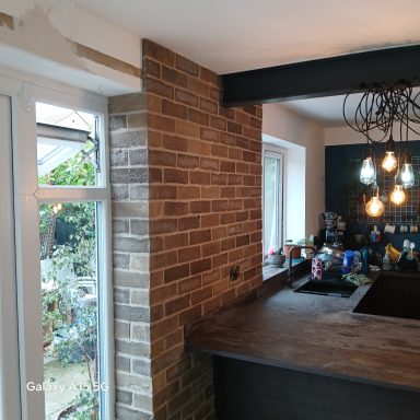 Brick slip kitchen feature wall in Flitwick, viewed from the window side beside the worktop