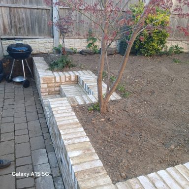 Completed cream brick retaining wall in Hitchin Finished cream brick retaining garden wall in Hitchin